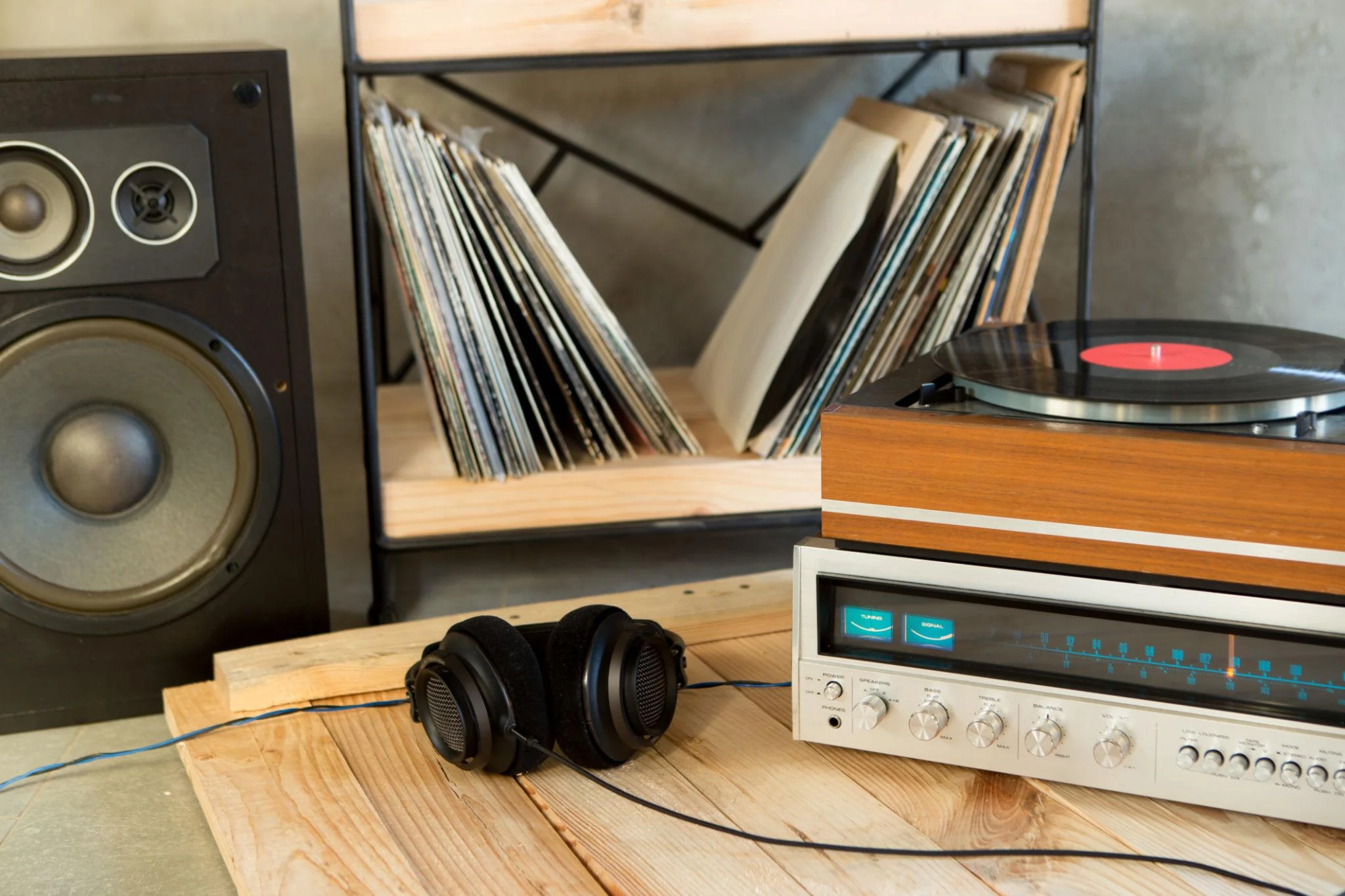 Turntable connected to stereo amplifier and bookshelf speakers in a warm living room setup