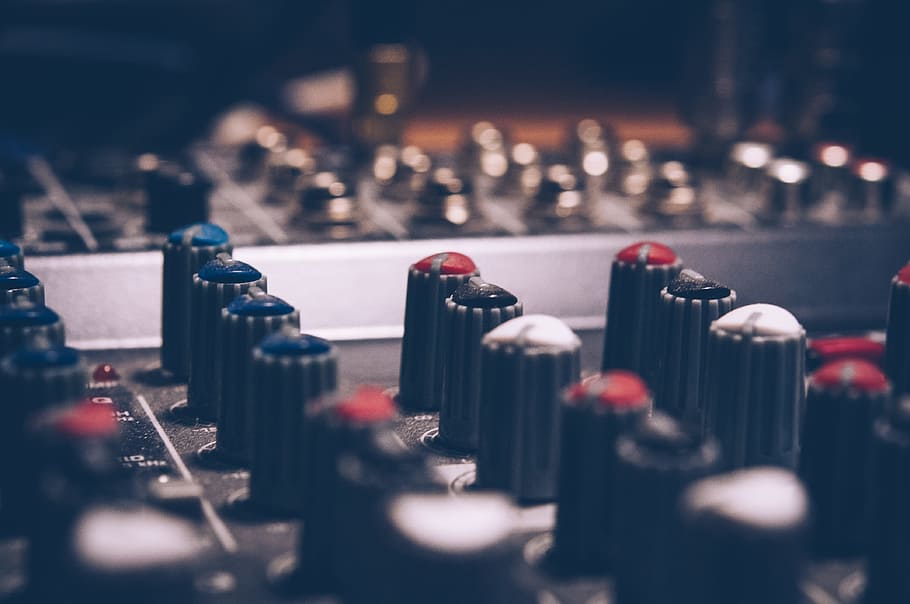 Close-up of audio mixer knobs used for fine-tuning EQ and amplifier calibration settings