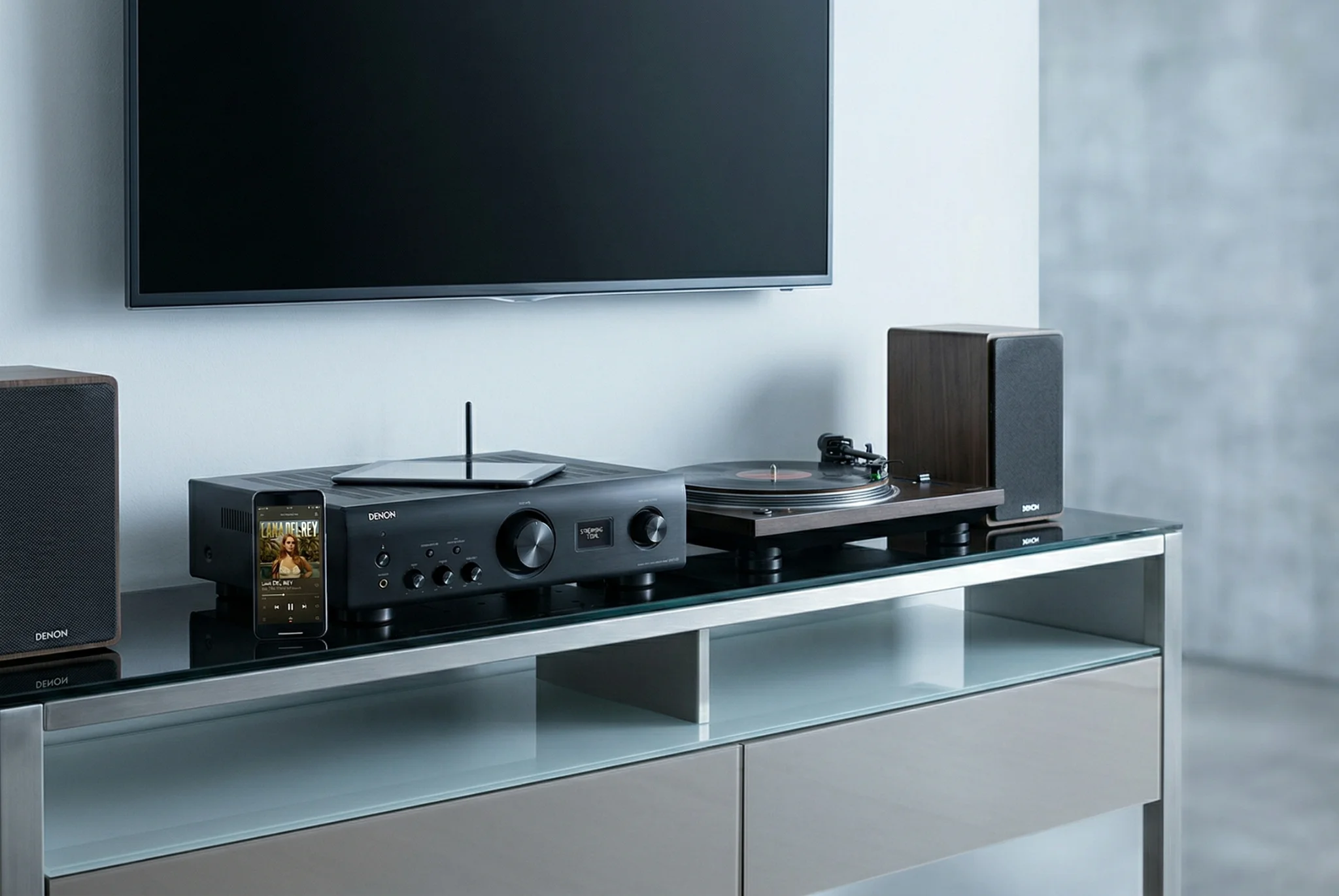 Denon PMA-900HNE review — streaming integrated amplifier in a modern connected living room with bookshelf speakers and turntable