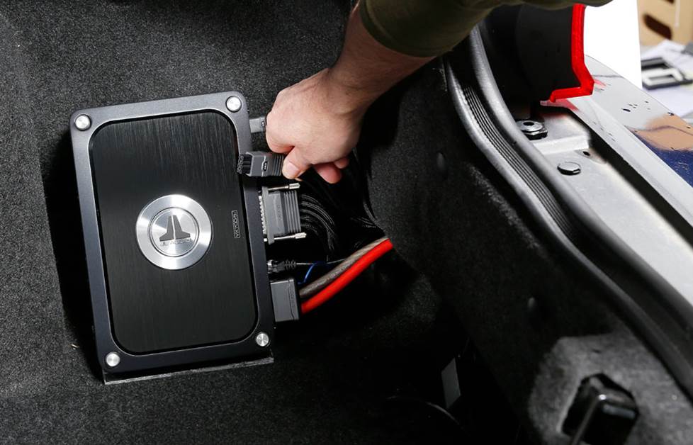 Inside view of trunk amplifier wiring and power setup