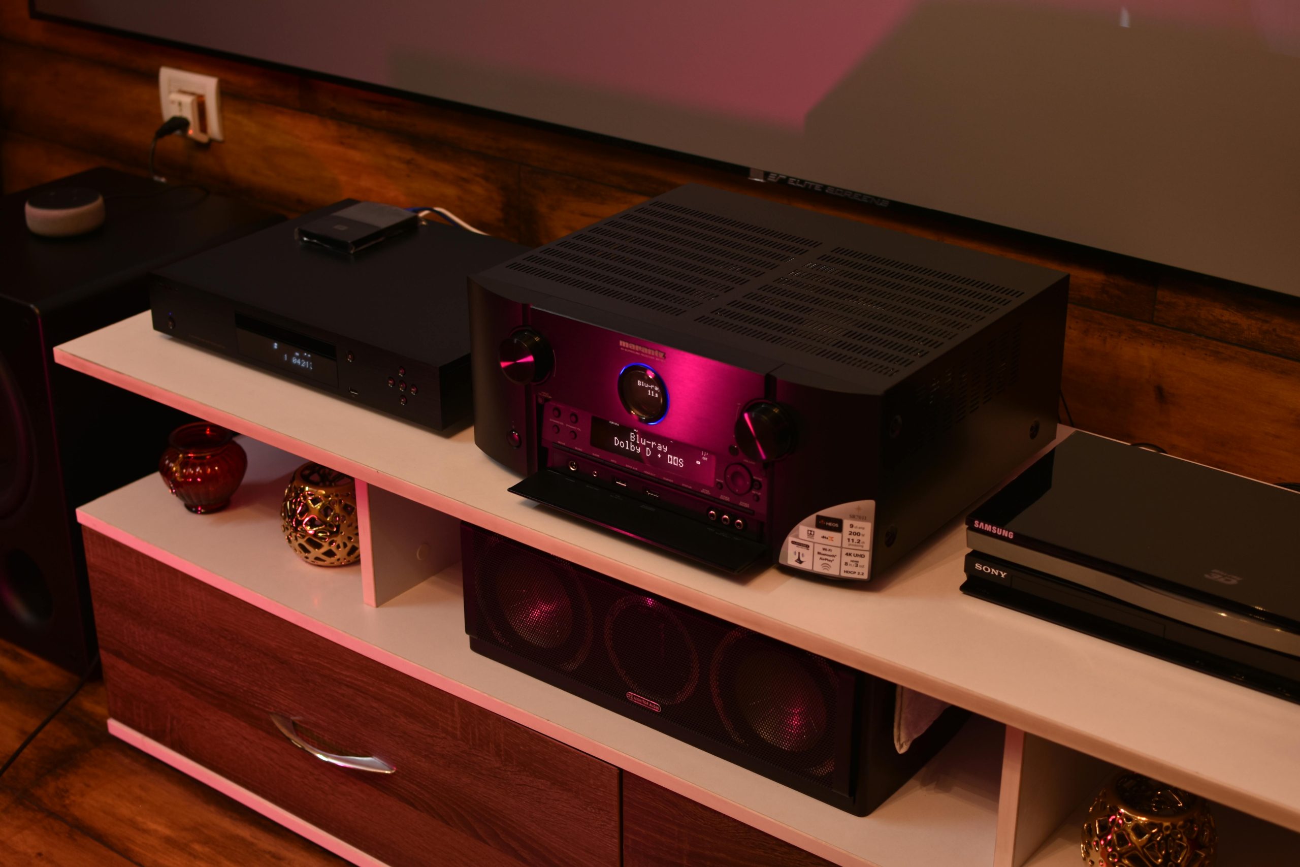 Budget home audio amplifier setup with speakers on a wooden desk