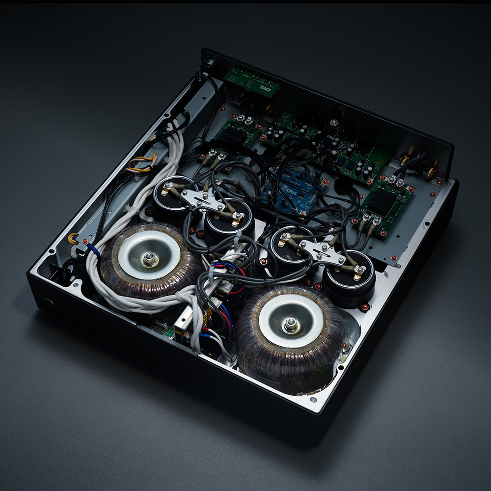 Internal components of a high-end amplifier showing dual transformers and organized circuitry layout