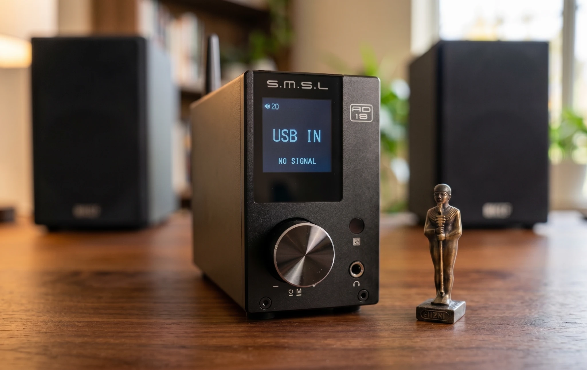SMSL AD18 desktop DAC amplifier in a PC listening setup with bookshelf speakers and monitor