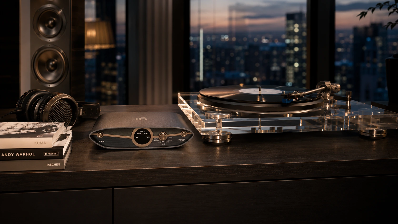iFi Zen Phono 3 high-end MM/MC phono preamp beside an acrylic audiophile turntable in a luxury penthouse vinyl listening setup