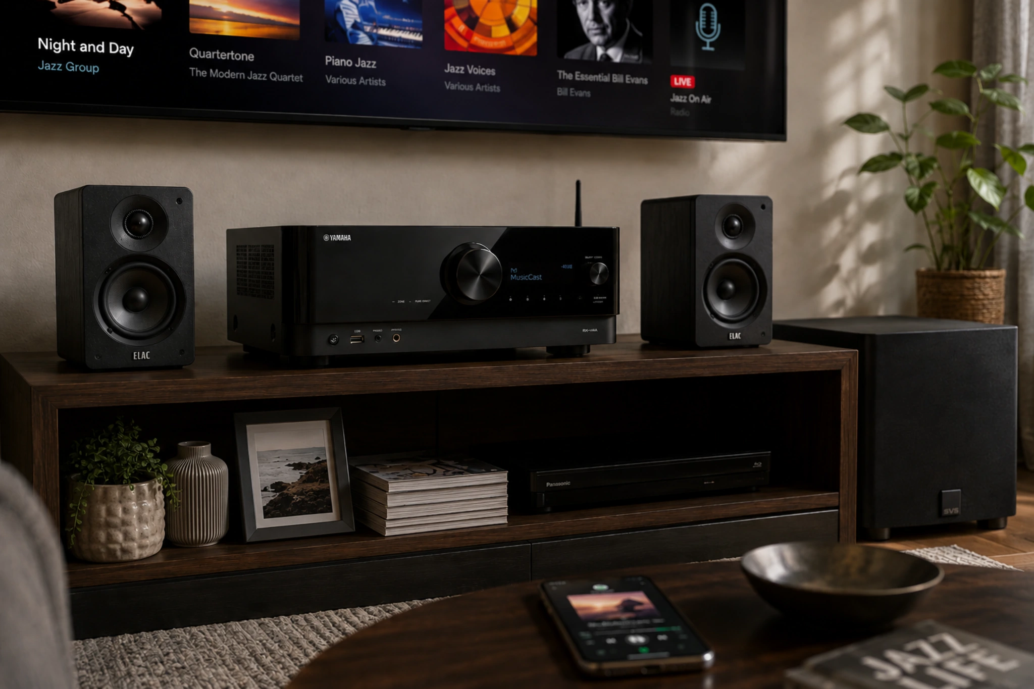 Yamaha RX-V4A review — MusicCast AV receiver in a home theater setup with bookshelf speakers, subwoofer, and smartphone music streaming control