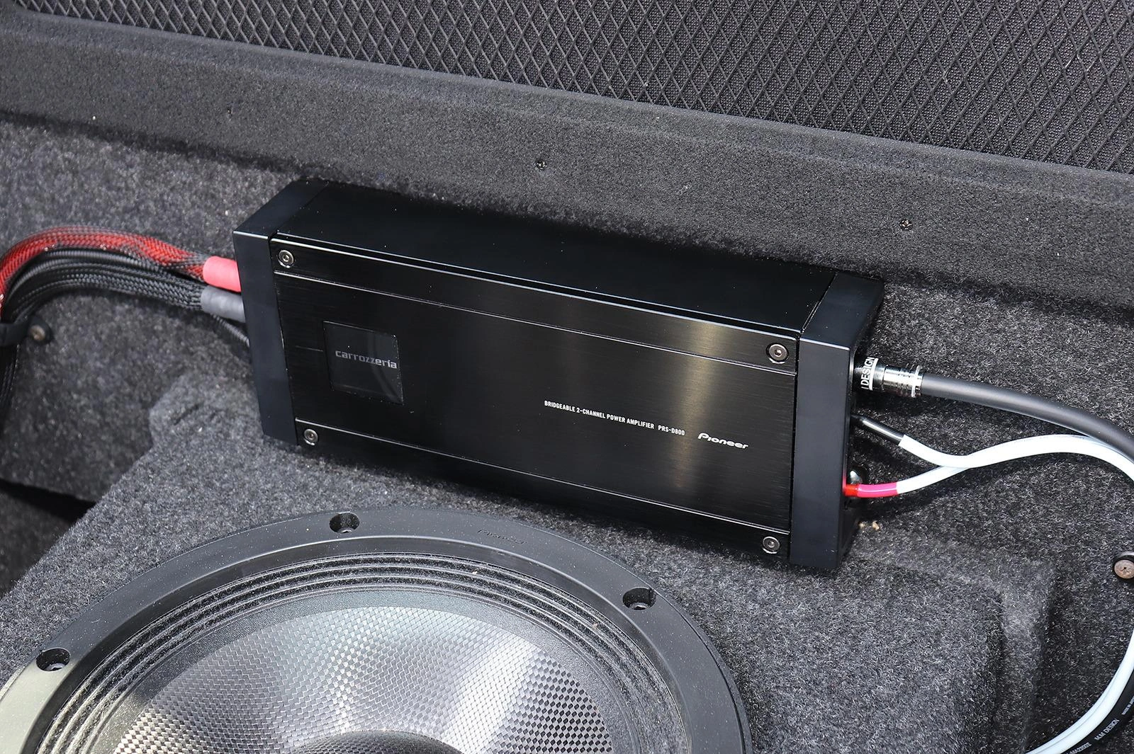 2-channel car amplifier installed in a vehicle trunk