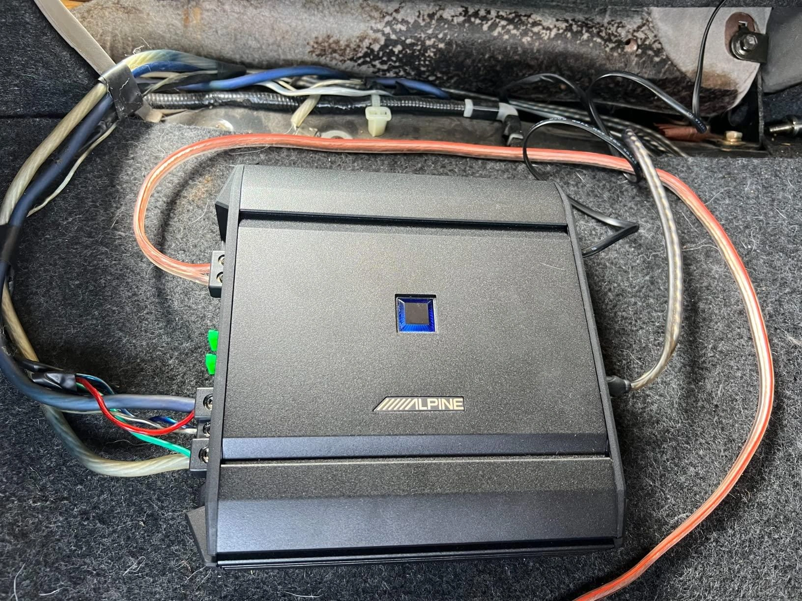 Alpine S-A60M monoblock amplifier mounted under a car seat