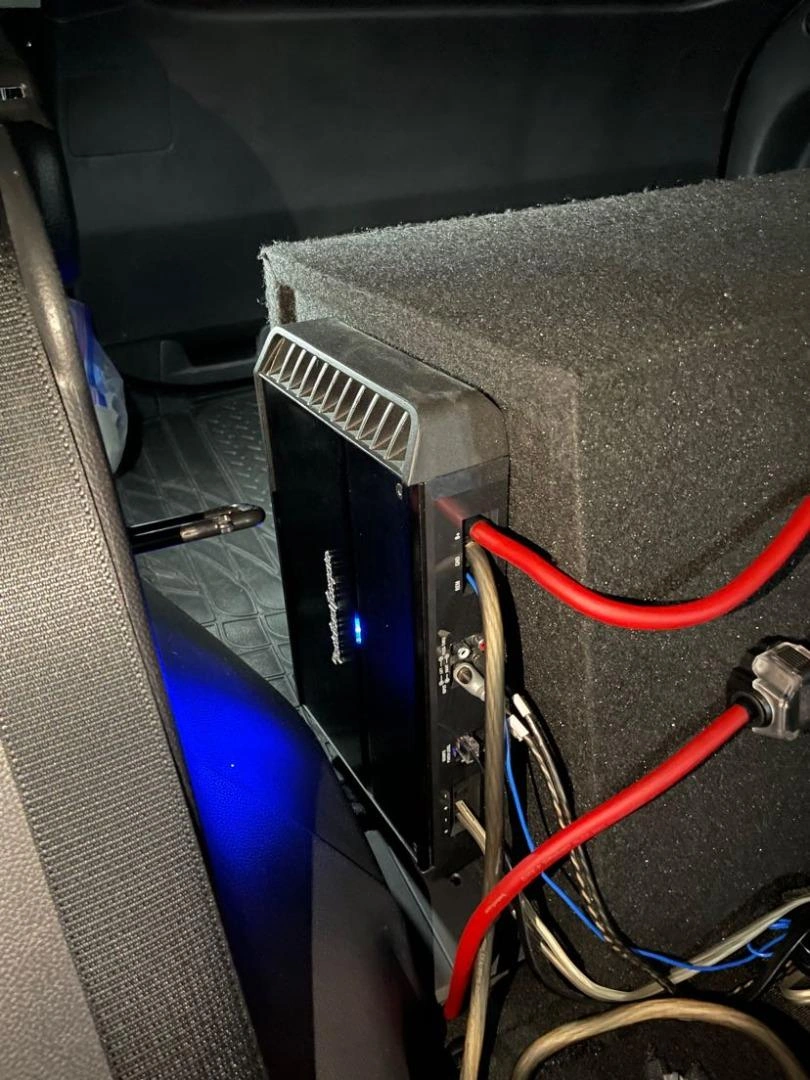 Rockford Fosgate P500X2 amplifier installed with subwoofer enclosure in a car trunk